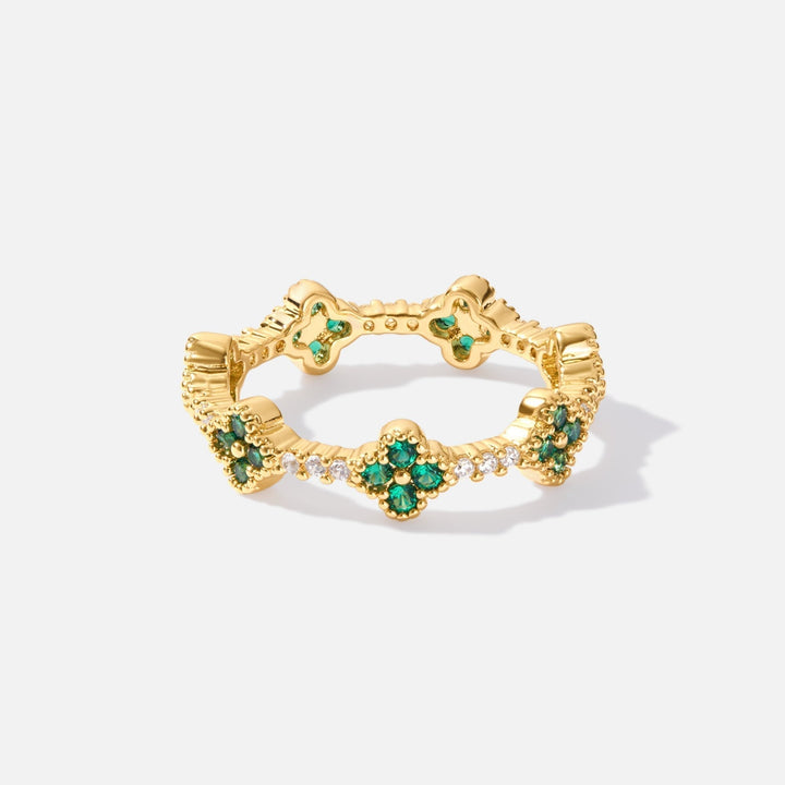 Annika – Anello placcato oro con dettagli floreali e un elemento in smeraldo.